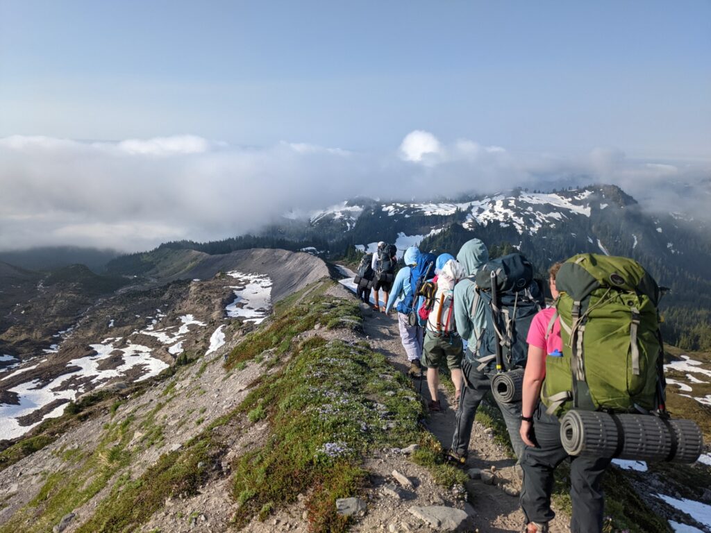Group taking part in outside exercise by hiking across a mountain